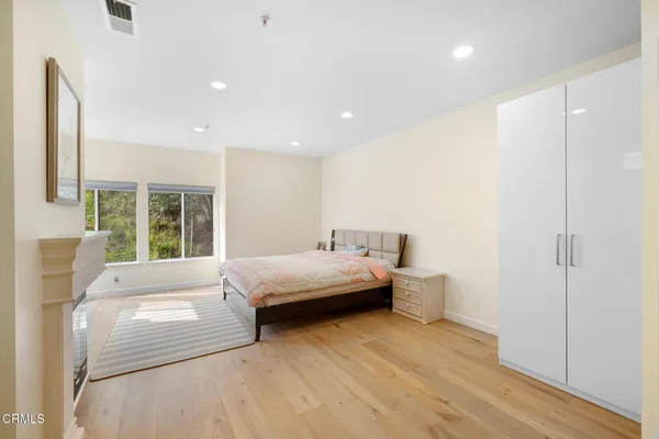 a spacious bedroom with a bed and a large window