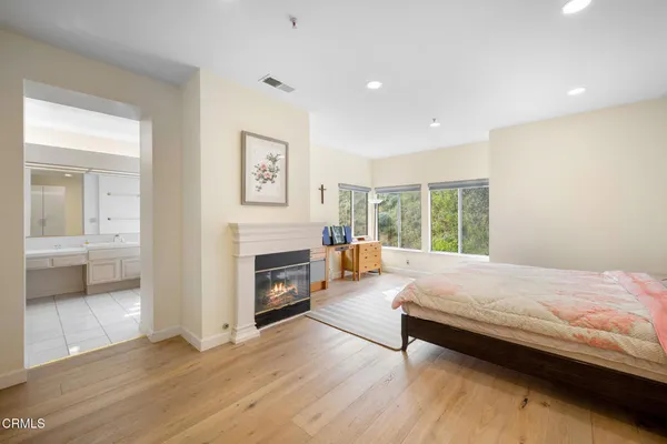 a bedroom with a bed and a fireplace