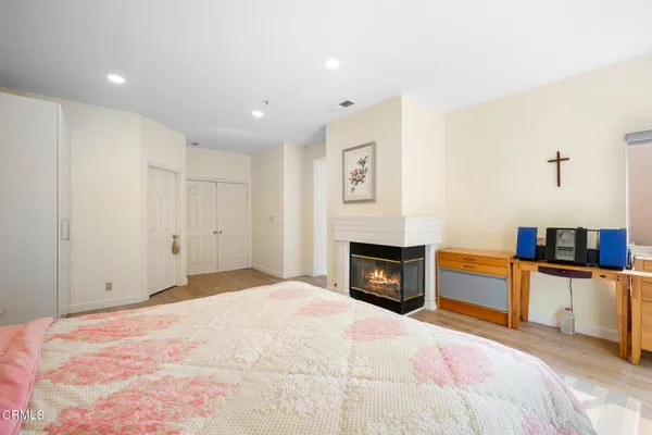 a spacious bedroom with a bed and a fireplace