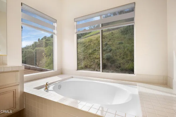 a bathroom with bathtub and window