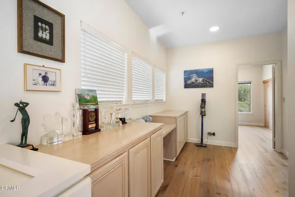 a view of a kitchen with a sink and dishwasher with wooden floor