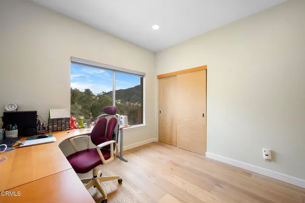 a living room with furniture a flat screen tv and a floor to ceiling window