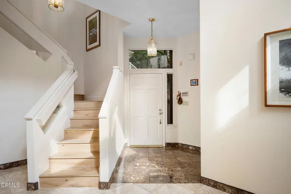 a view of entryway and hall with wooden floor