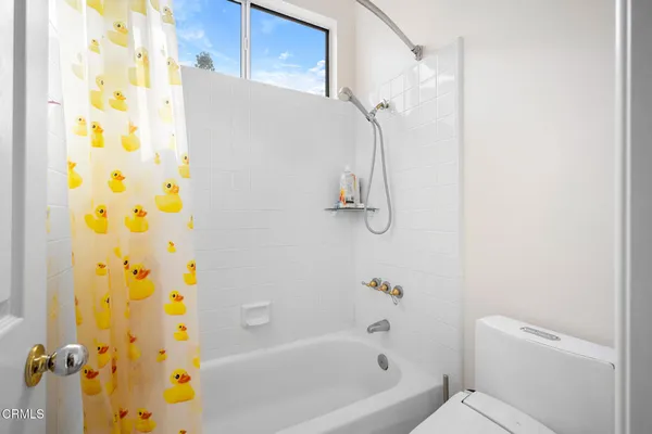 a bathroom with a bathtub and shower
