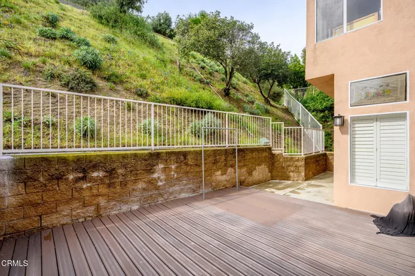 a view of a balcony with a floor to ceiling window and wooden floor