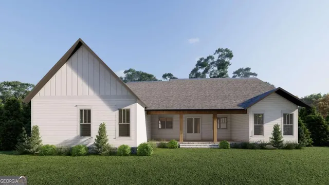 a front view of a house with a yard and plants