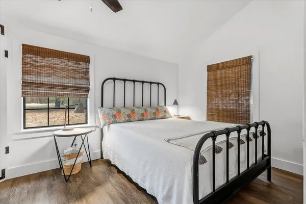 a bedroom with a bed and wooden floor