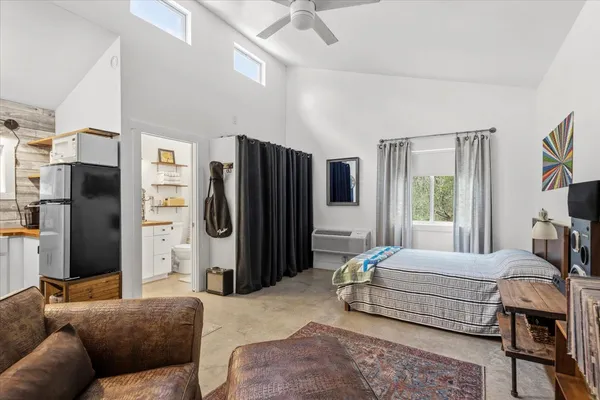 a bedroom with a bed closet and a window