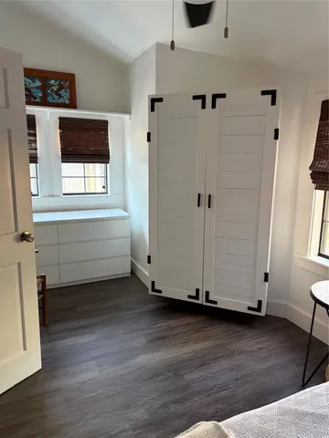 a view of a room with wooden floor