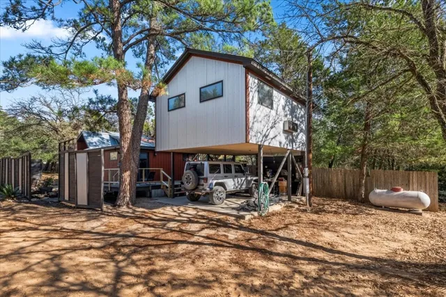 a view of a house with a yard and sitting area