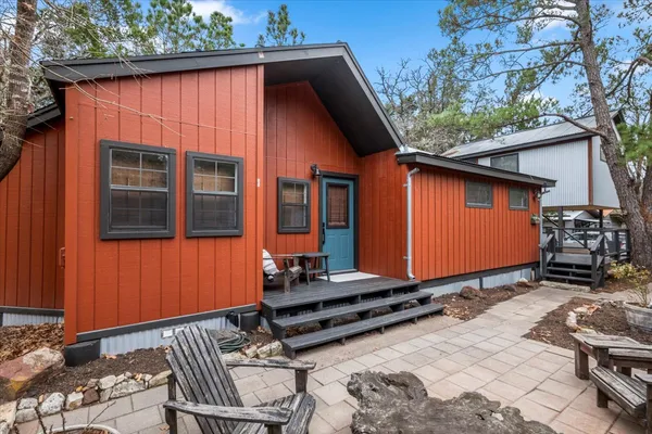 a backyard of a house with barbeque oven table and chairs