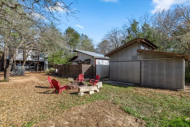 a backyard of a house with table and chairs