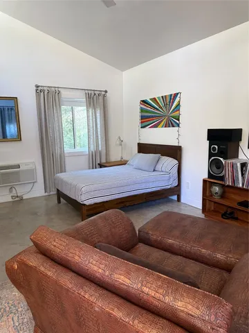 a bedroom with furniture and a window