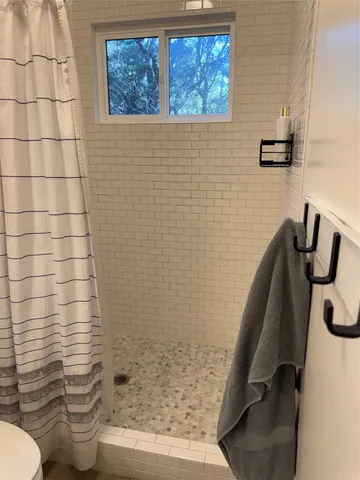 a bathroom with a toilet and a shower
