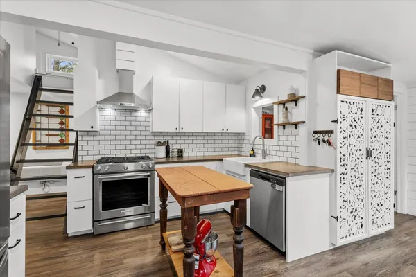 a kitchen with stainless steel appliances granite countertop a stove and a sink