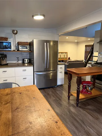 a kitchen with stainless steel appliances granite countertop a refrigerator and a stove