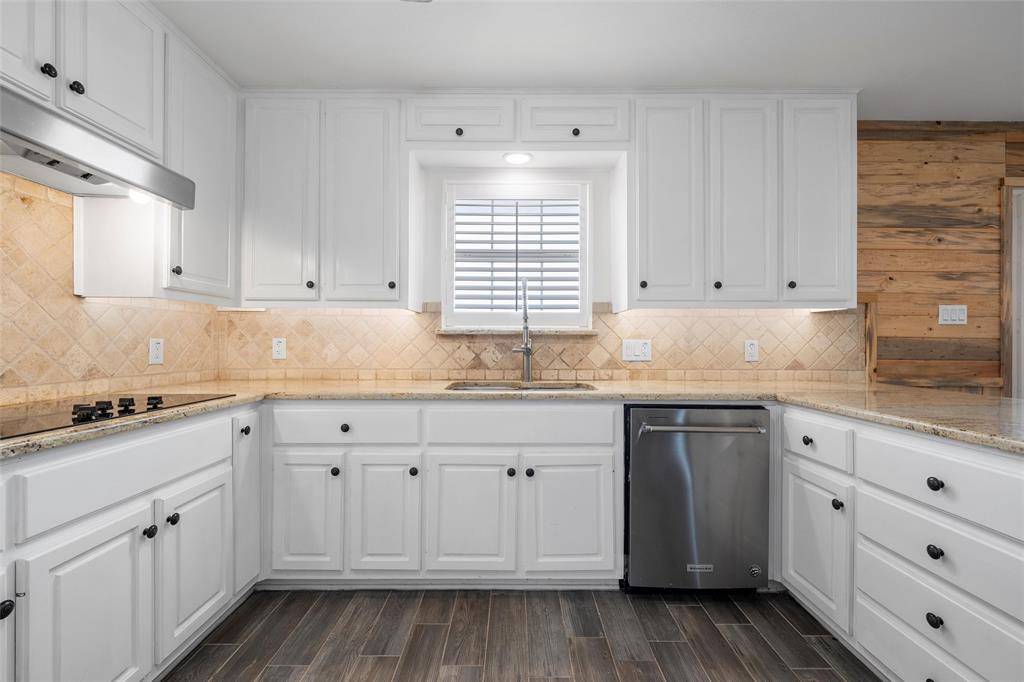 5112 Old Caufield Ranch Road McGregor, TX 76657 - Photo 14 of 39 a kitchen with granite countertop white cabinets and sink