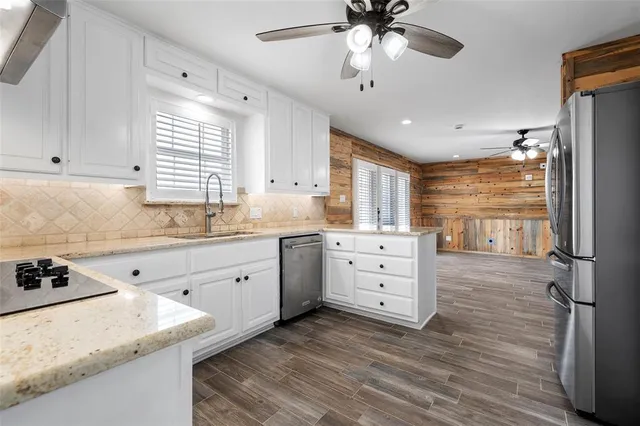 a kitchen with cabinets appliances and a window
