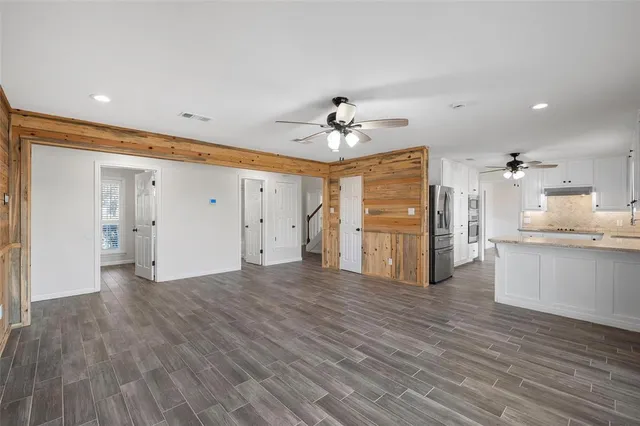 a view of a kitchen with wooden floor and a sink