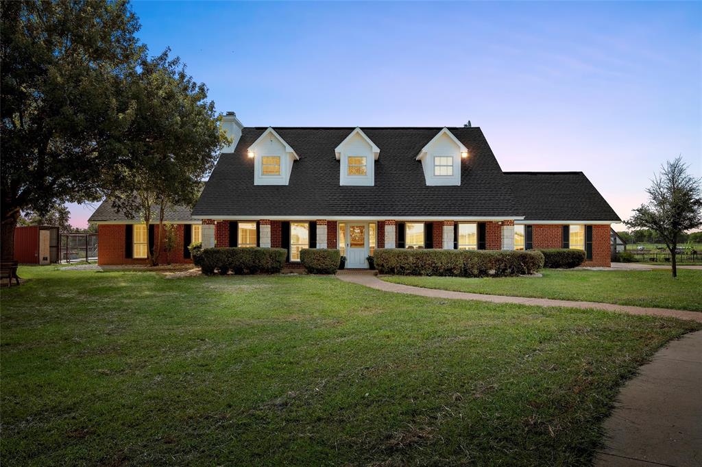 5112 Old Caufield Ranch Road McGregor, TX 76657 - Photo 2 of 39 a front view of a house with a garden