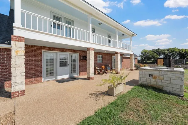 a view of a house with a yard and sitting area