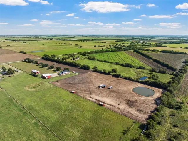 an aerial view of a house with outdoor space swimming pool