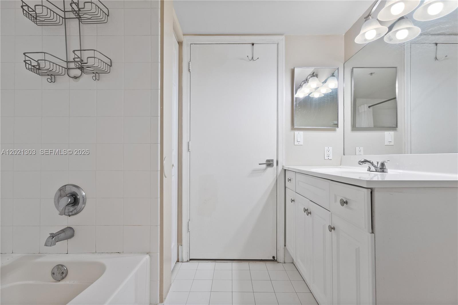 2123 Renaissance Boulevard, Unit 201 Miramar, FL 33025 - Photo 15 of 22 a bathroom with a tub sink and mirror