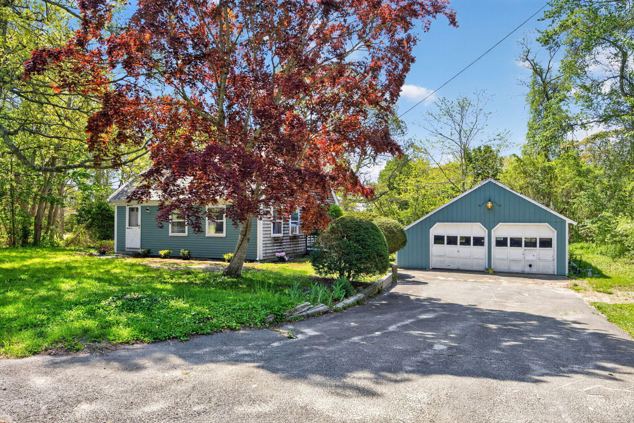 23 Nickerson Road Orleans, MA 02653 - Photo 38 of 54 a front view of a house with a garden and tree