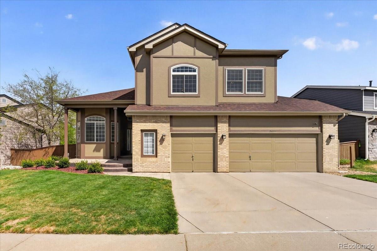 a front view of a house with a yard and garage