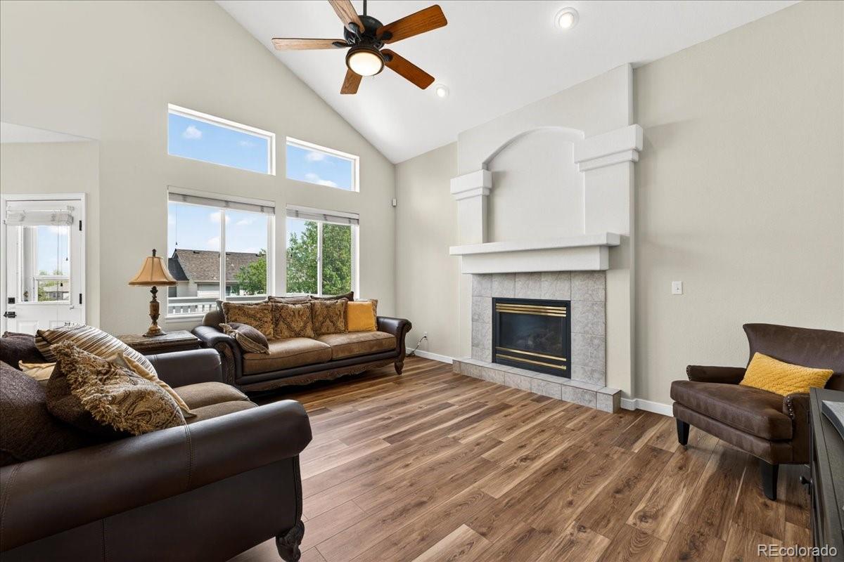 9477 Burgundy Circle Highlands Ranch, CO 80126 - Photo 18 of 50 a living room with furniture and a fireplace