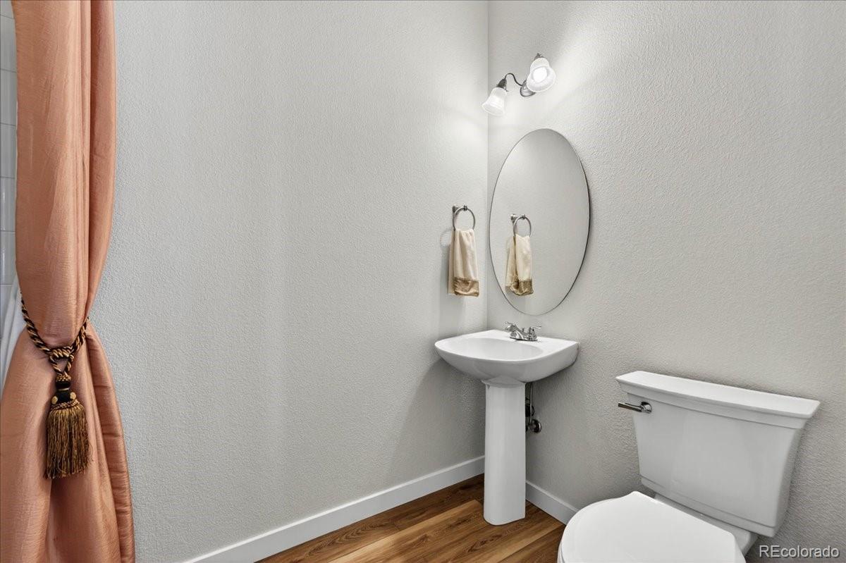 9477 Burgundy Circle Highlands Ranch, CO 80126 - Photo 20 of 50 a bathroom with a toilet a sink and a mirror