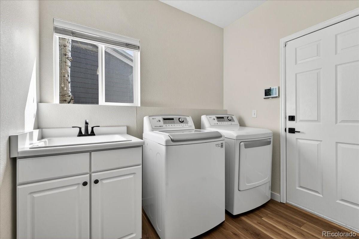 9477 Burgundy Circle Highlands Ranch, CO 80126 - Photo 21 of 50 a utility room with cabinets washer and dryer