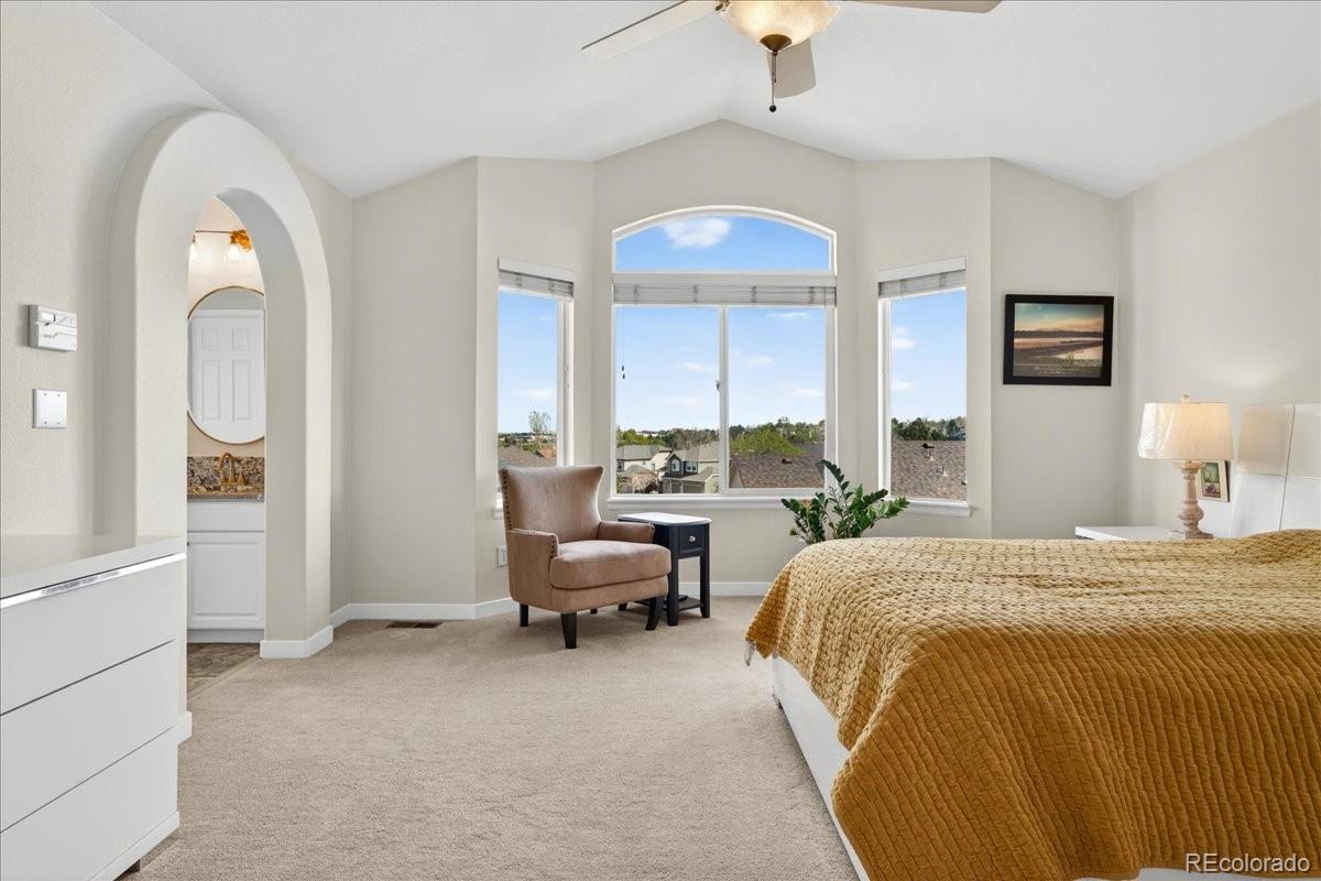 9477 Burgundy Circle Highlands Ranch, CO 80126 - Photo 24 of 50 a bed room with a bed and a chandelier