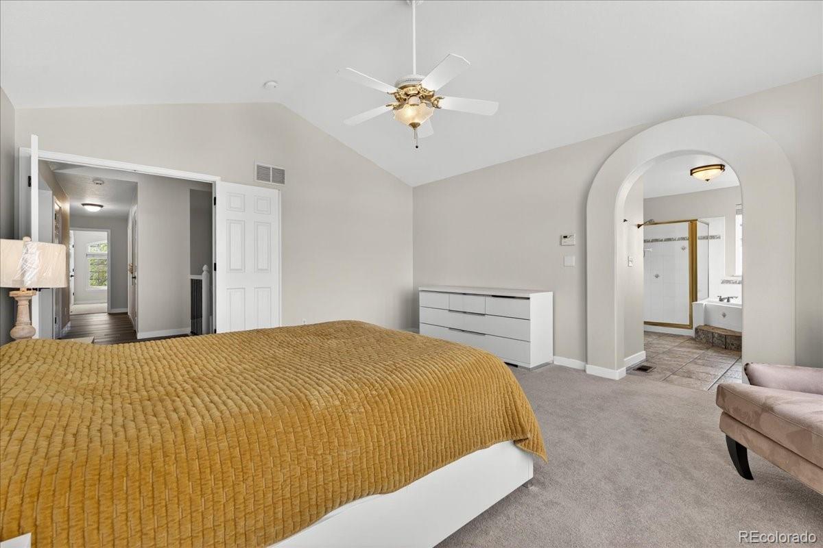 9477 Burgundy Circle Highlands Ranch, CO 80126 - Photo 25 of 50 a bedroom with a bed and ceiling fan