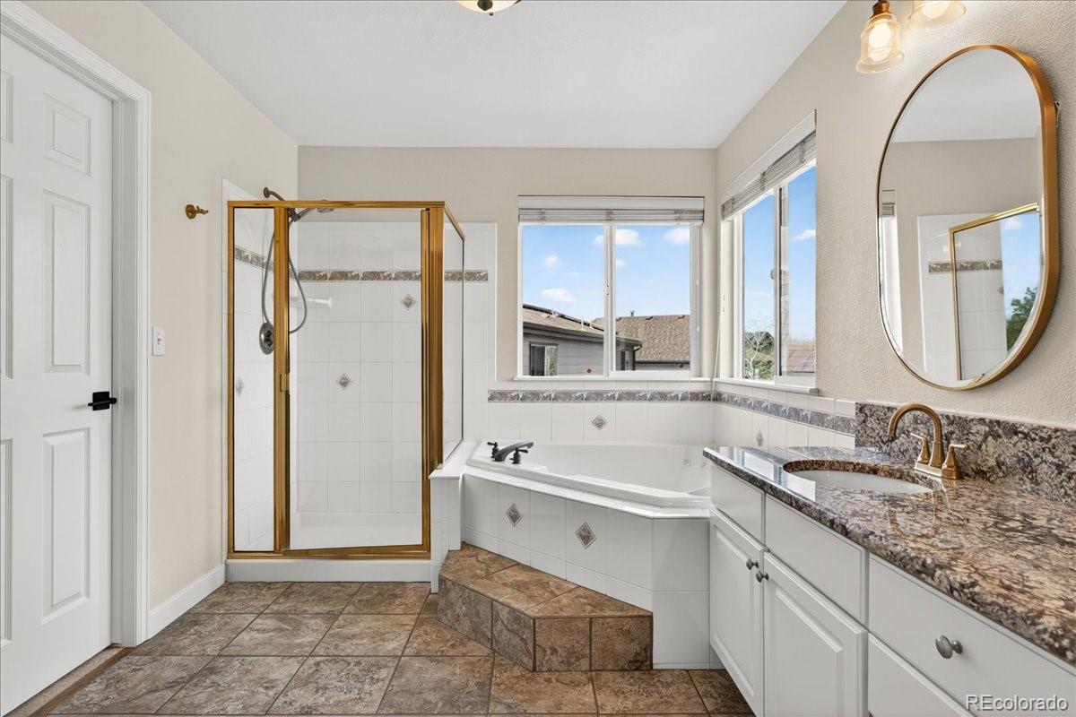 9477 Burgundy Circle Highlands Ranch, CO 80126 - Photo 28 of 50 a bathroom with a sink double vanity and a mirror