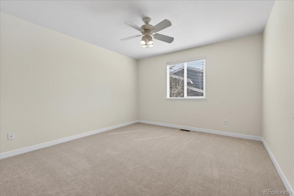 9477 Burgundy Circle Highlands Ranch, CO 80126 - Photo 30 of 50 an empty room with a window and a ceiling fan