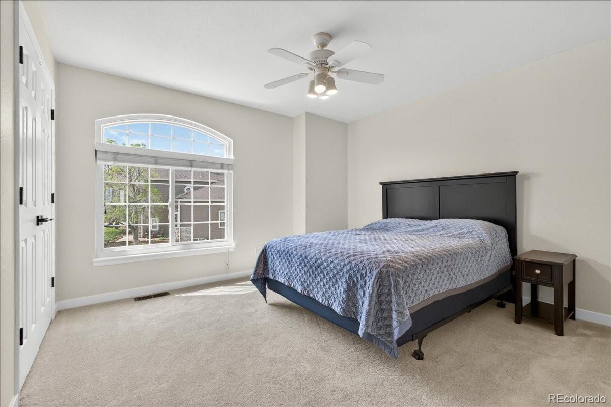 9477 Burgundy Circle Highlands Ranch, CO 80126 - Photo 33 of 50 a spacious bedroom with a bed and a large window