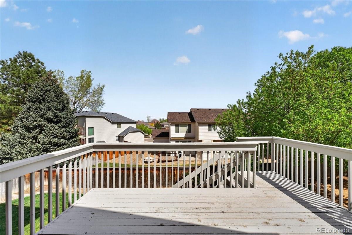 9477 Burgundy Circle Highlands Ranch, CO 80126 - Photo 44 of 50 a view of a roof deck with wooden floor and fence