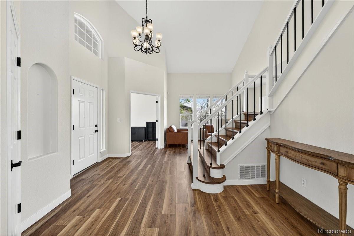 9477 Burgundy Circle Highlands Ranch, CO 80126 - Photo 5 of 50 a view of entryway and hall with wooden floor
