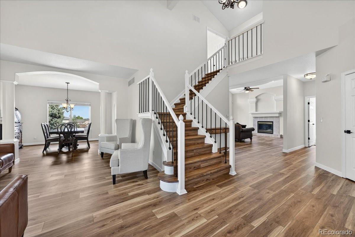 9477 Burgundy Circle Highlands Ranch, CO 80126 - Photo 6 of 50 a view of entryway livingroom and hall with wooden floor