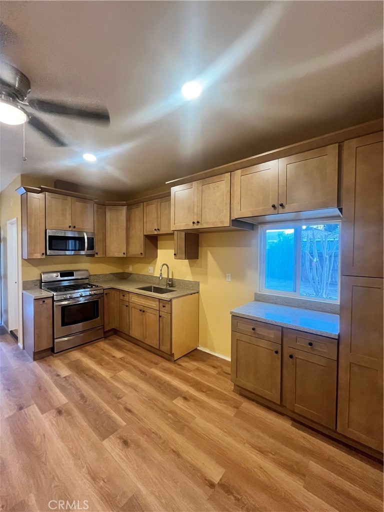 4136 1/2 Eileen Street Riverside, CA 92504 - Photo 1 of 10 a kitchen with granite countertop a sink cabinets and stainless steel appliances