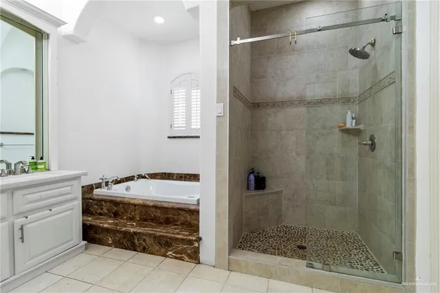 a bathroom with a shower sink and mirror
