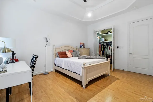 a white bed sitting in a bedroom next to a window