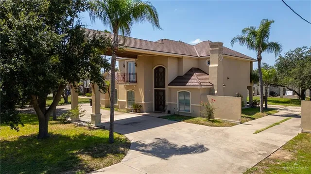 a front view of a house with a garden