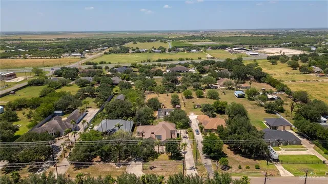 an aerial view of residential houses with outdoor space and swimming pool