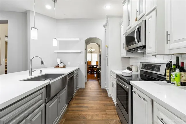 a large kitchen with stainless steel appliances granite countertop a lot of counter space and cabinets