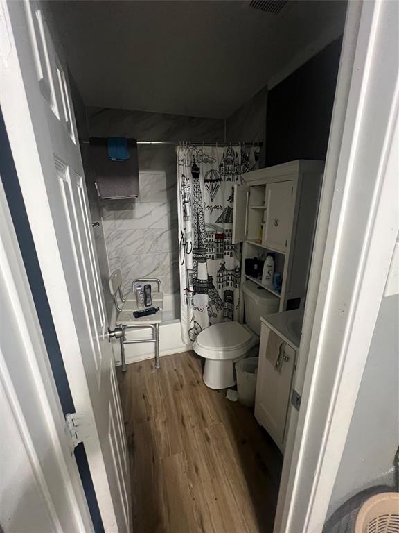 1722 Proctor Street Grand Prairie, TX 75051 - Photo 16 of 39 Bathroom featuring vanity, a shower with shower curtain, and dark wood finished floors