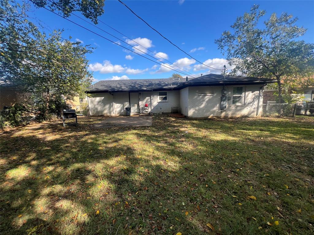 1722 Proctor Street Grand Prairie, TX 75051 - Photo 17 of 39 Rear view of house featuring brick siding, a patio area, and a shingled roof