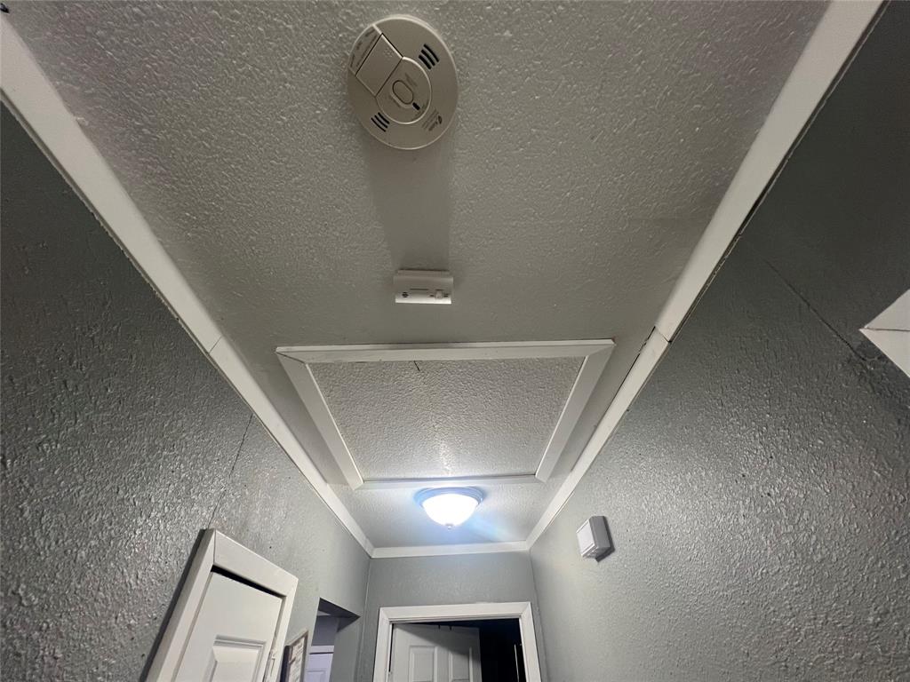 1722 Proctor Street Grand Prairie, TX 75051 - Photo 26 of 39 Detailed view of a textured ceiling and a textured wall