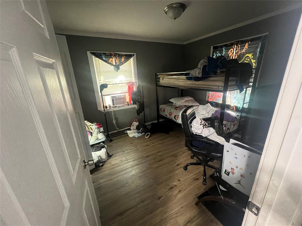 1722 Proctor Street Grand Prairie, TX 75051 - Photo 3 of 39 Bedroom featuring dark wood-type flooring and crown molding